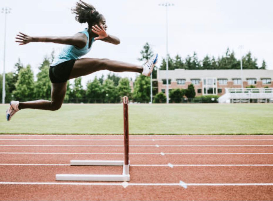 Hurdler jumping over hurdle